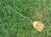 Fly swatter laying in the grass