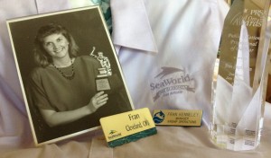 Some memories from SEaWorld including a photo, an award and name tags. 